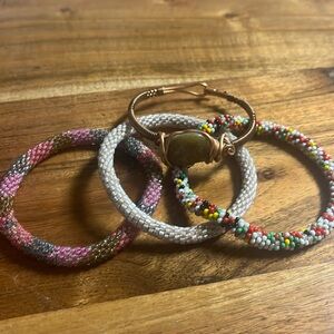 4 bracelets. 3 beaded and one copper with stone.